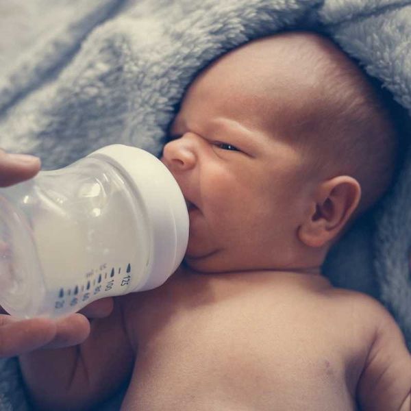 infant being bottle fed