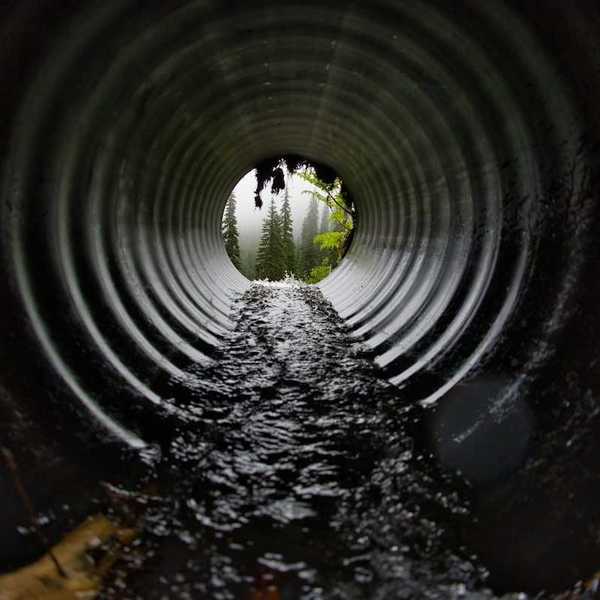 Interior of a wastewater pipe showing some accumulated sludge