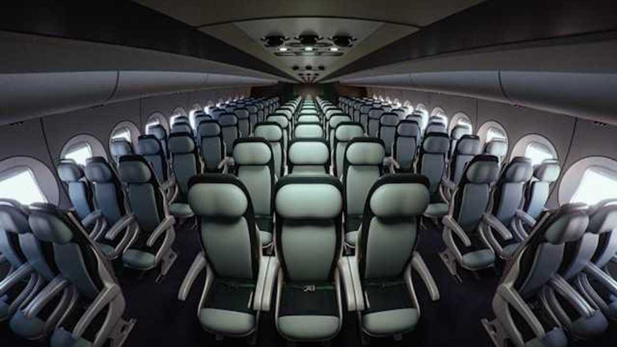 Interior of an airplane with seats stretching into the distance
