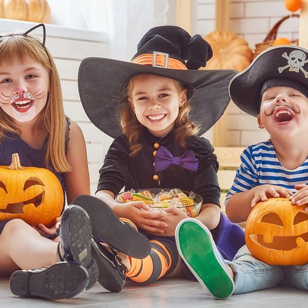 kids in halloween costumes laughing
