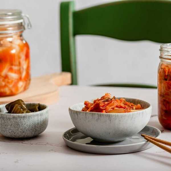 Kimchi and fermented variations in bowls and jars