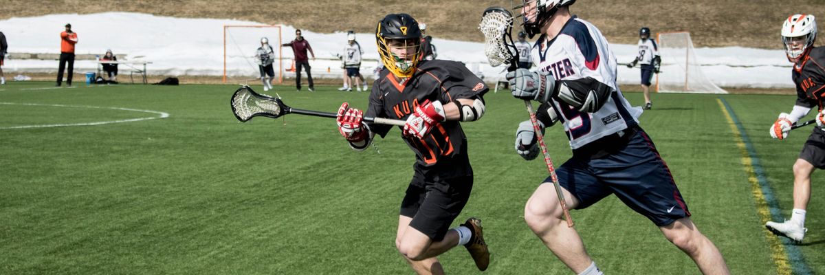 lacrosse players on turf field