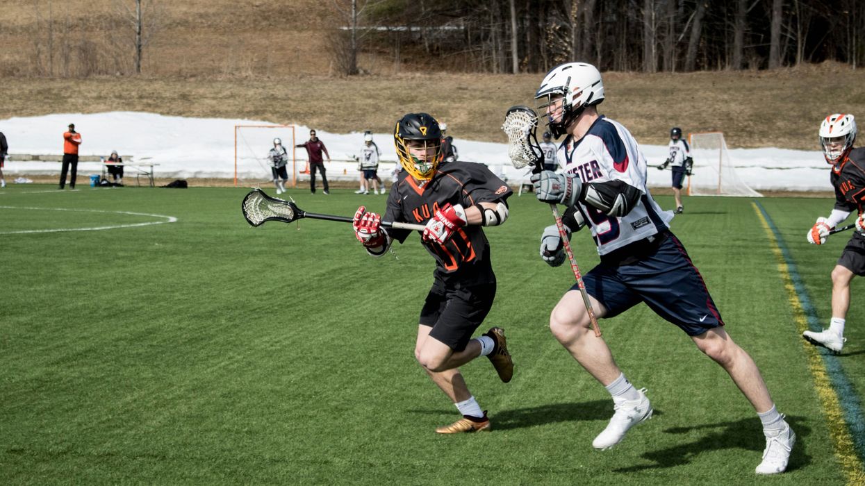 lacrosse players on turf field