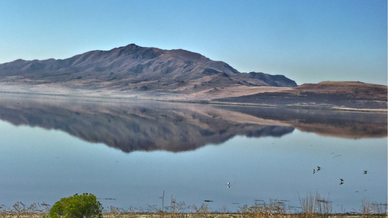 Lake reflecting mountains in background.