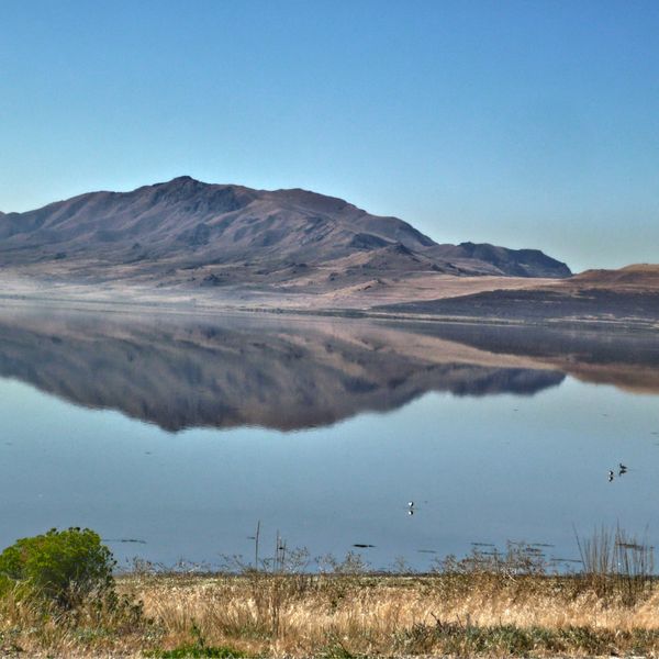 Lake reflecting mountains in background.