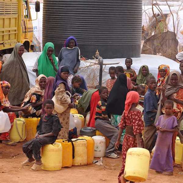 Large group of African people waiting to get water.