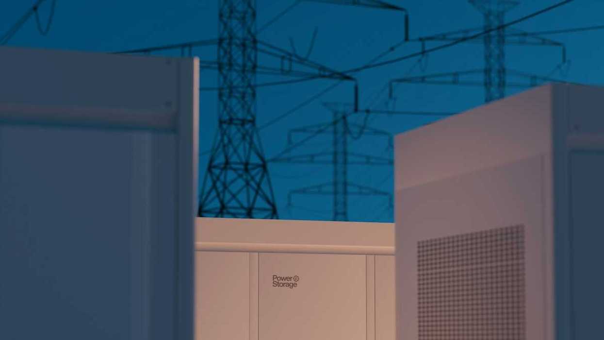 Large storage batteries with transmission lines in background