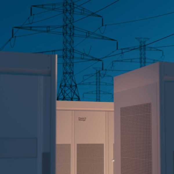 Large storage batteries with transmission lines in background