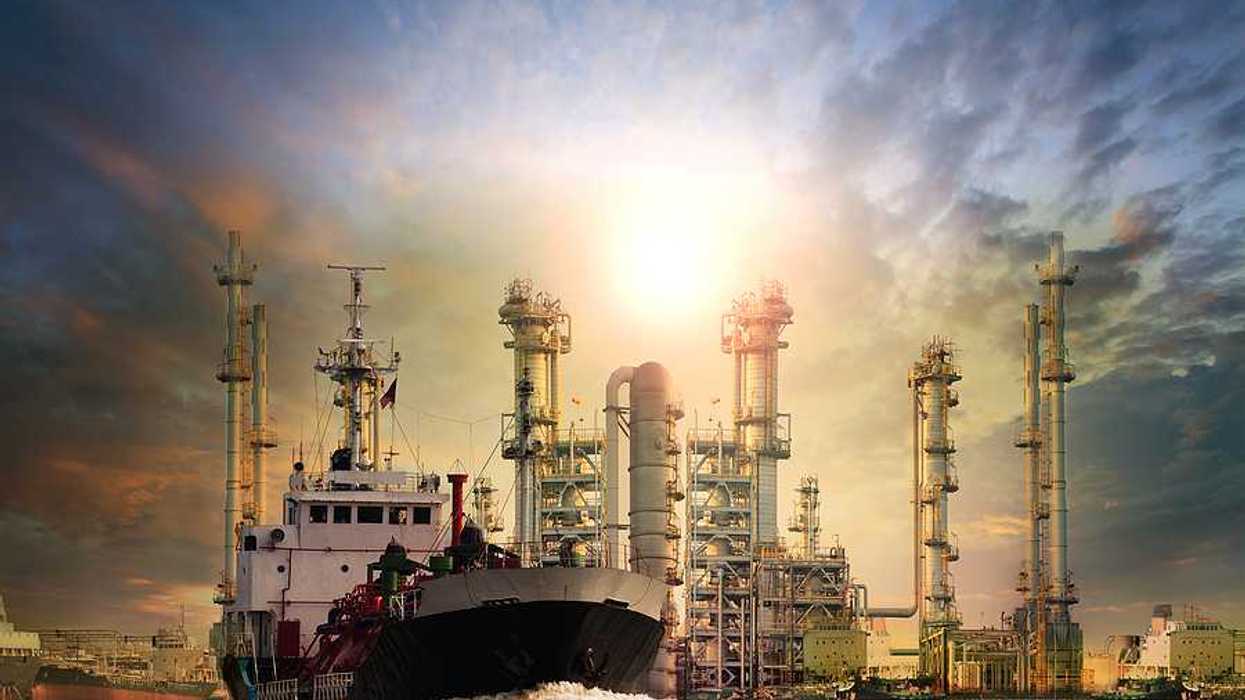 LNG tanker ship with oil & gas refinery plant in background