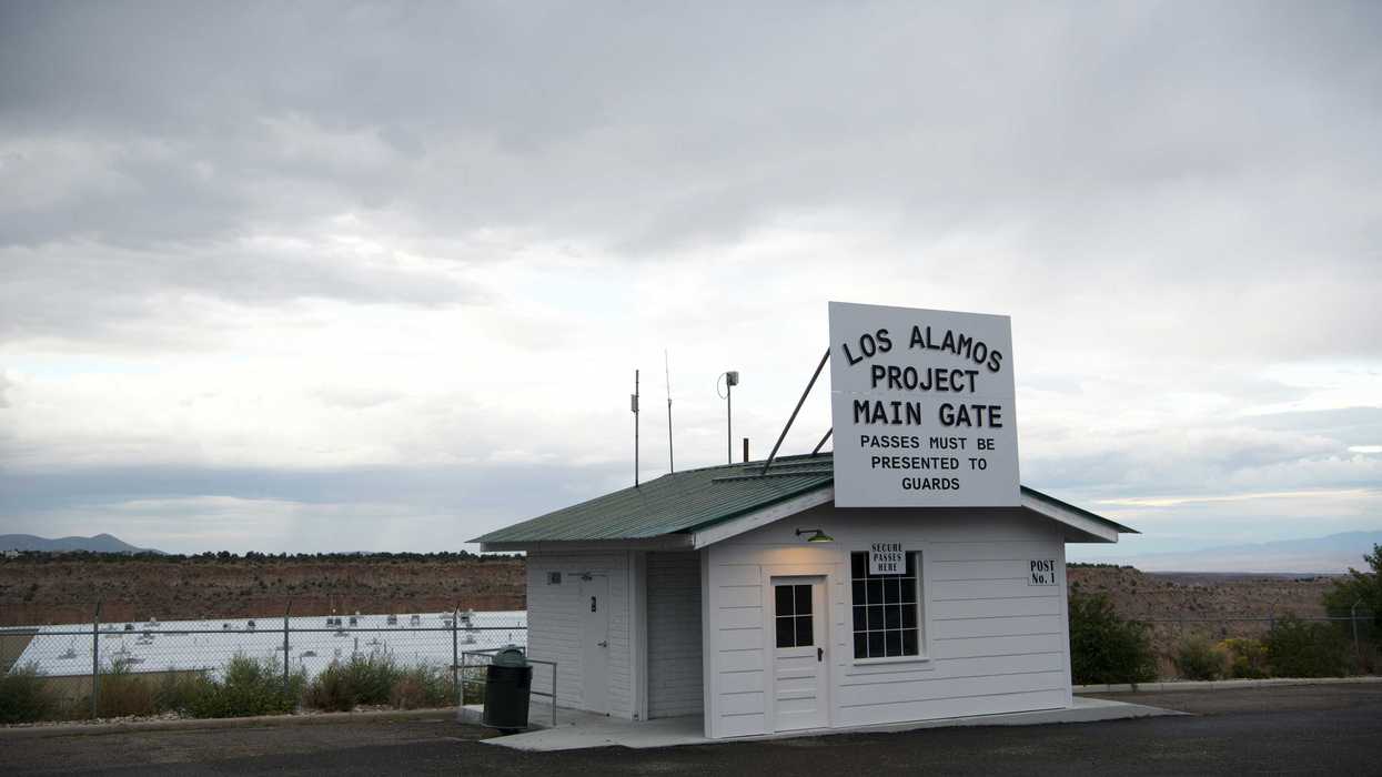 Los Alamos National Laboratory main gate with desert landscape in background.