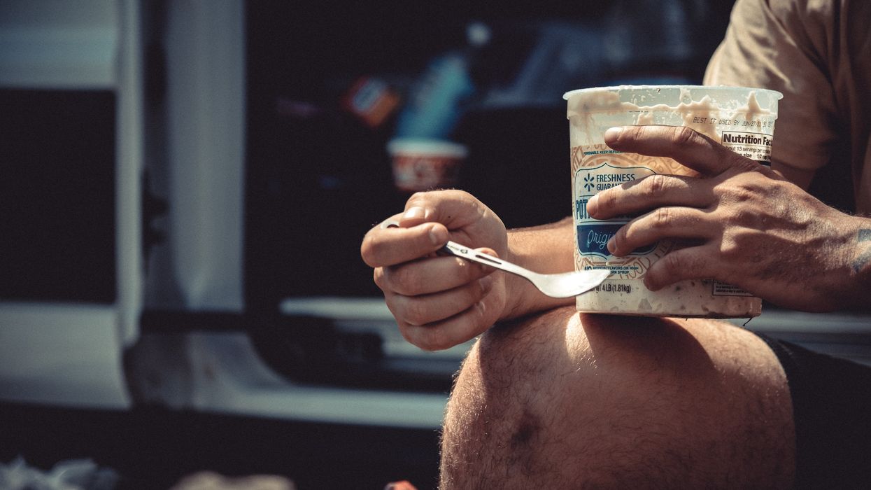 man eating from a plastic container