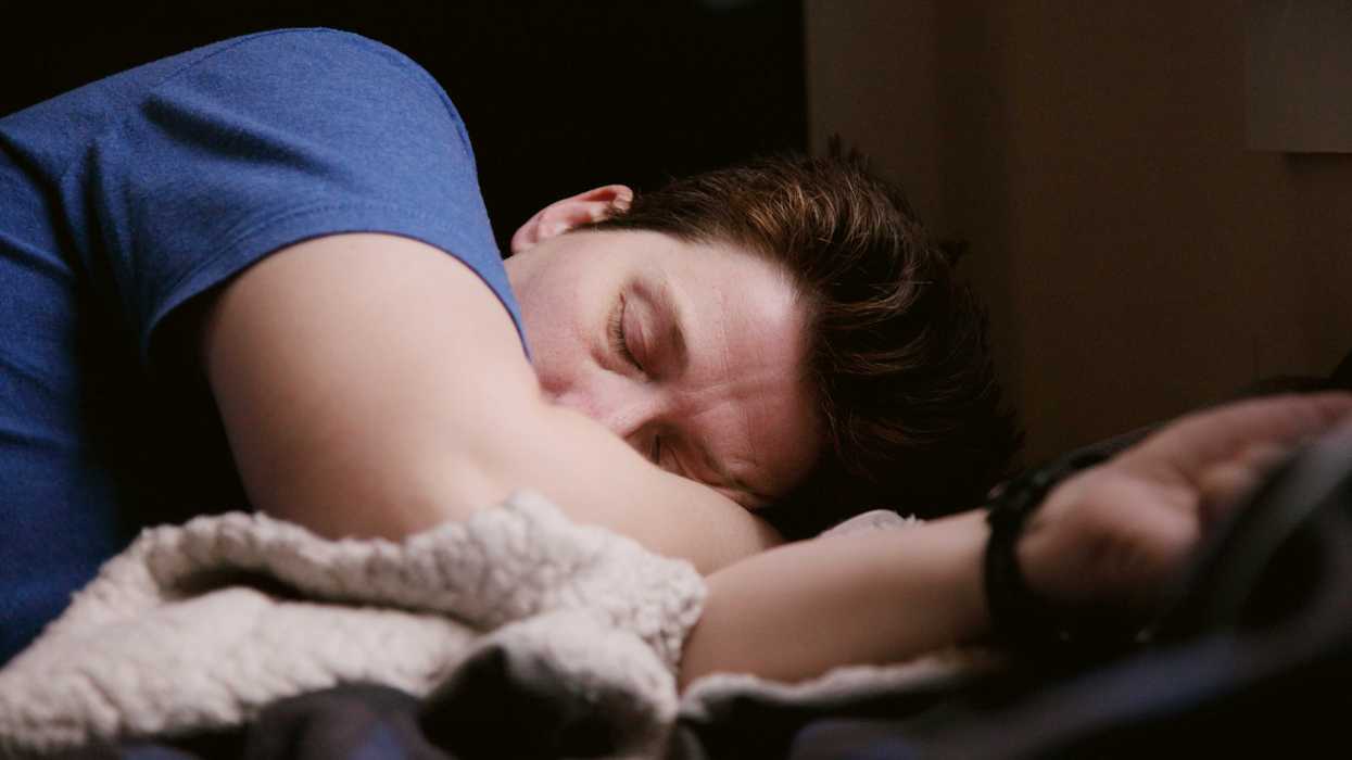 man in blue shirt sleeping.