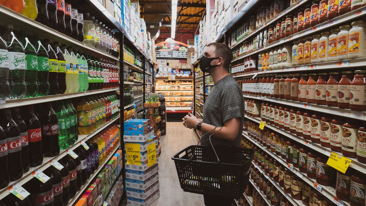 man in supermarket shopping aisle