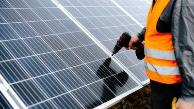 Man installing a solar panel