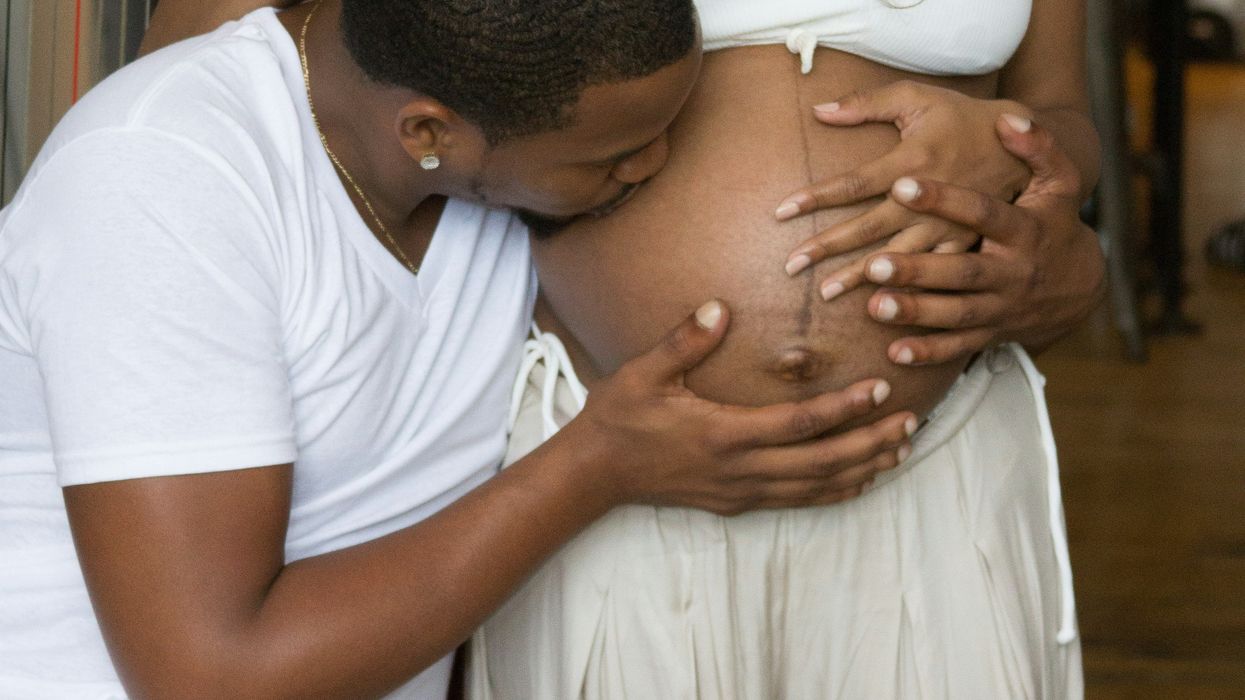 man kissing pregnant woman