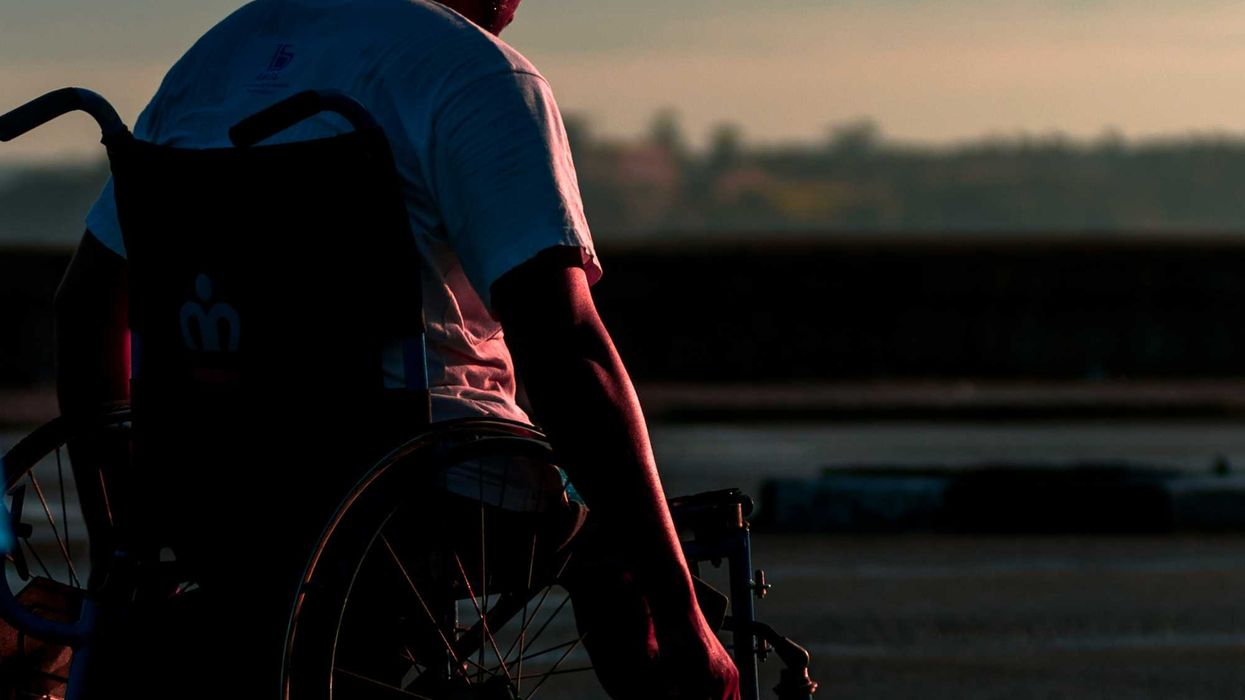 man sitting in wheelchair during daytime.