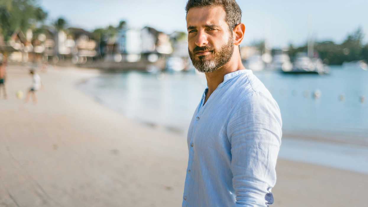 man standing on beach during daytime.