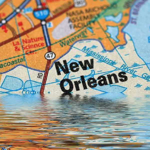 Map of New Orleans with a flood illustration indicating NOLA is sinking