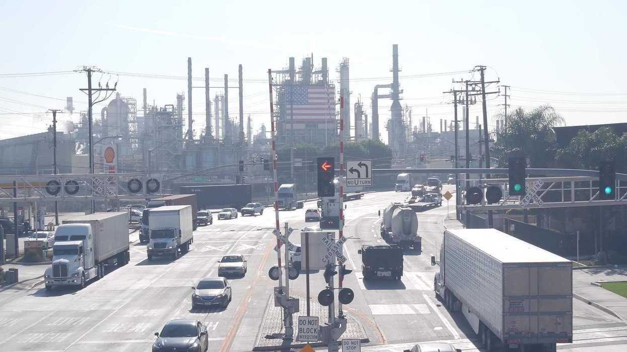 Marathon oil refinery, Los Angeles. Petroleum, chemicals and gasoline factory. American flag and smokestacks of industrial petrochemicals plant.