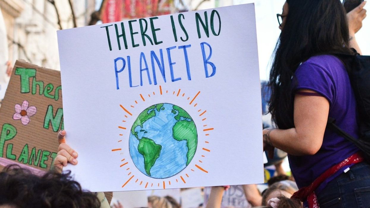 Marching for climate with sign: "There Is No Planet B"