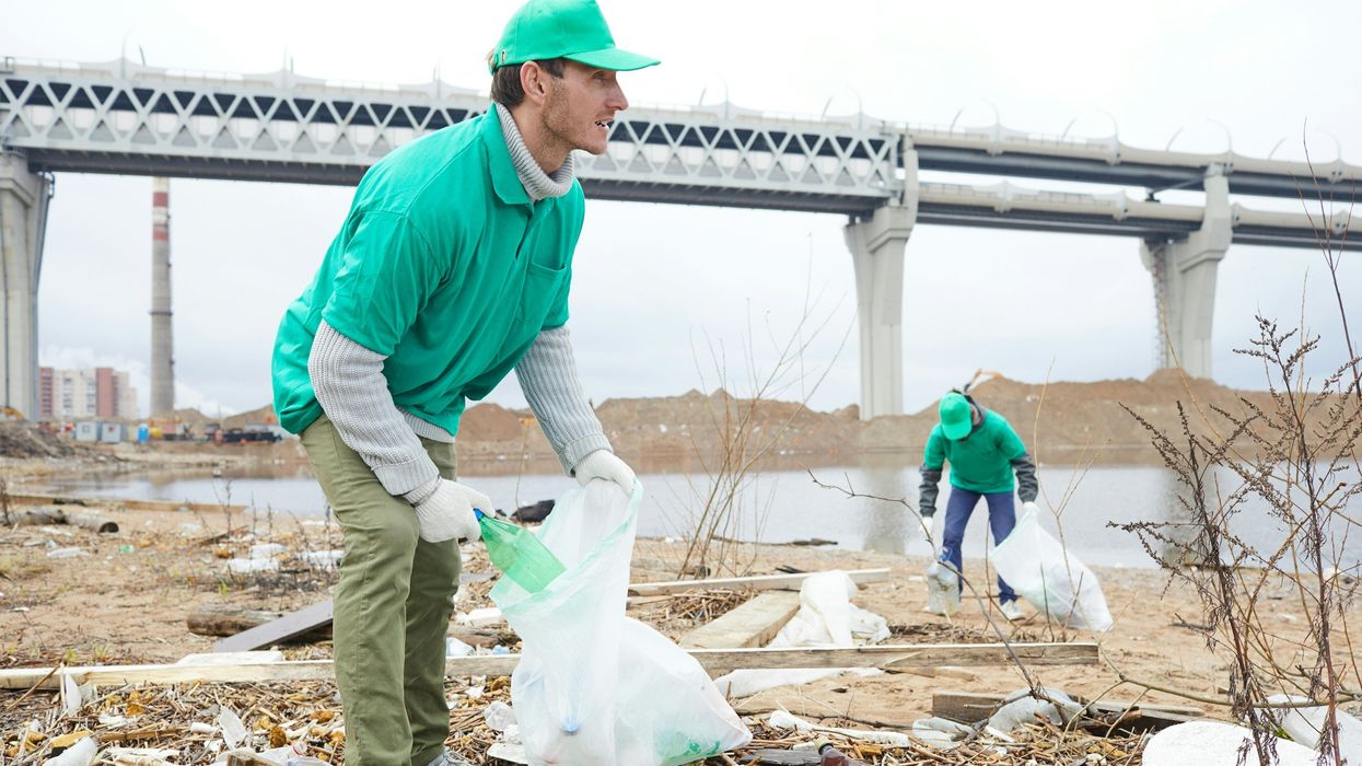 men cleaning up plastic bags
