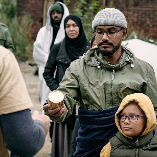 Men, women, and children lined up to receive food rations