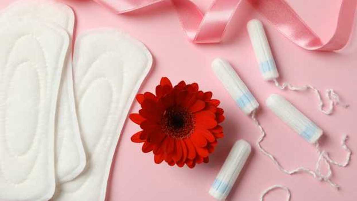 Menstrual pads and tampons on a pink background