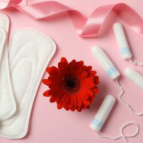 Menstrual pads and tampons on a pink background