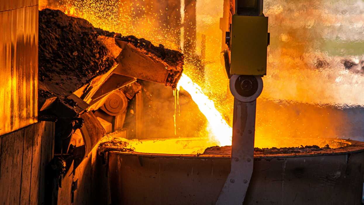 Molten steel pouring from a pipe.