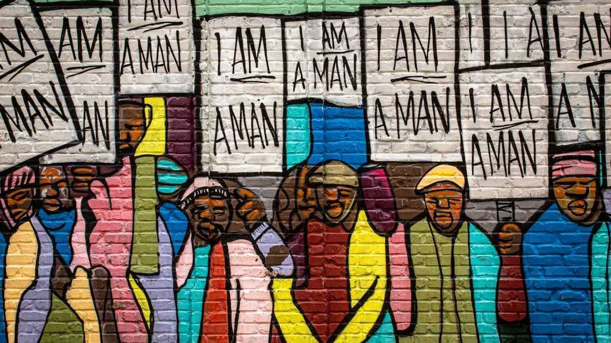 Mural on a building in Memphis painted during the Civil Rights movement, depicting black men holding signs that read "I am a man."
