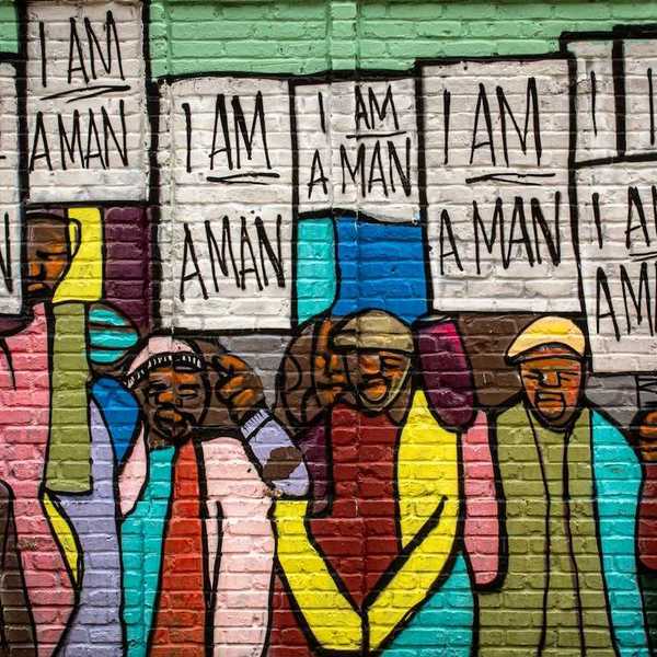 Mural on a building in Memphis painted during the Civil Rights movement, depicting black men holding signs that read "I am a man."