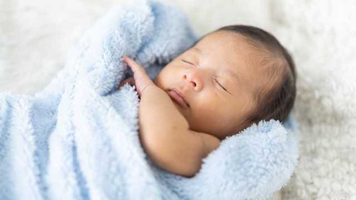 Newborn baby wrapped in a blue blanket