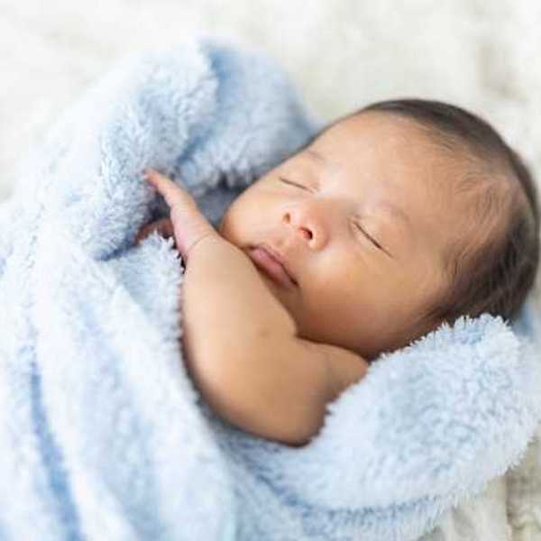Newborn baby wrapped in a blue blanket