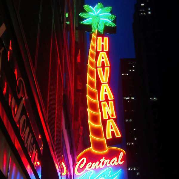 Nighttime view of decorative neon sign reading "Havana Central"
