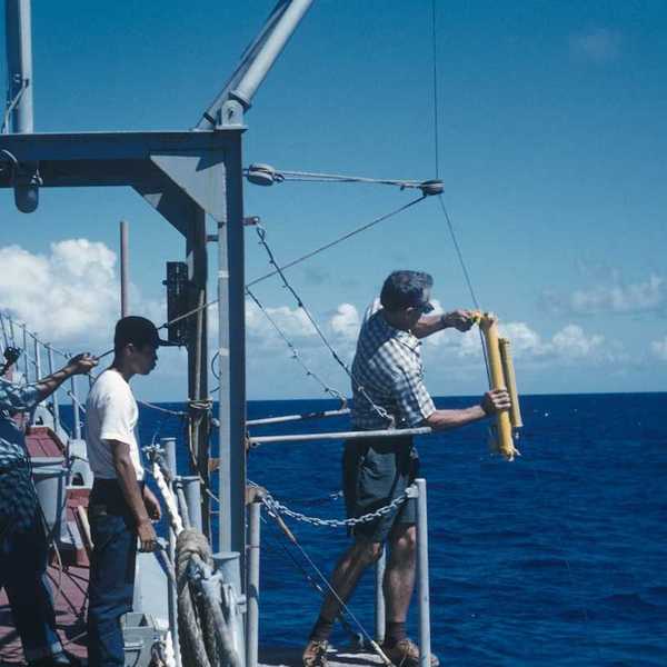 Oceanographic operations on the Coast and Geodetic Survey Ship PIONEER. Attaching Nansen water sampling bottle and thermometer to wire.