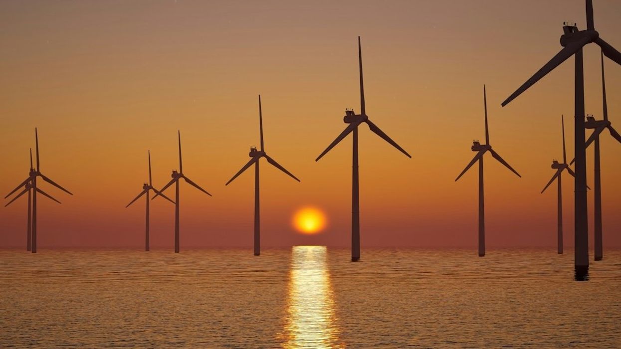 off shore wind farm against setting sun