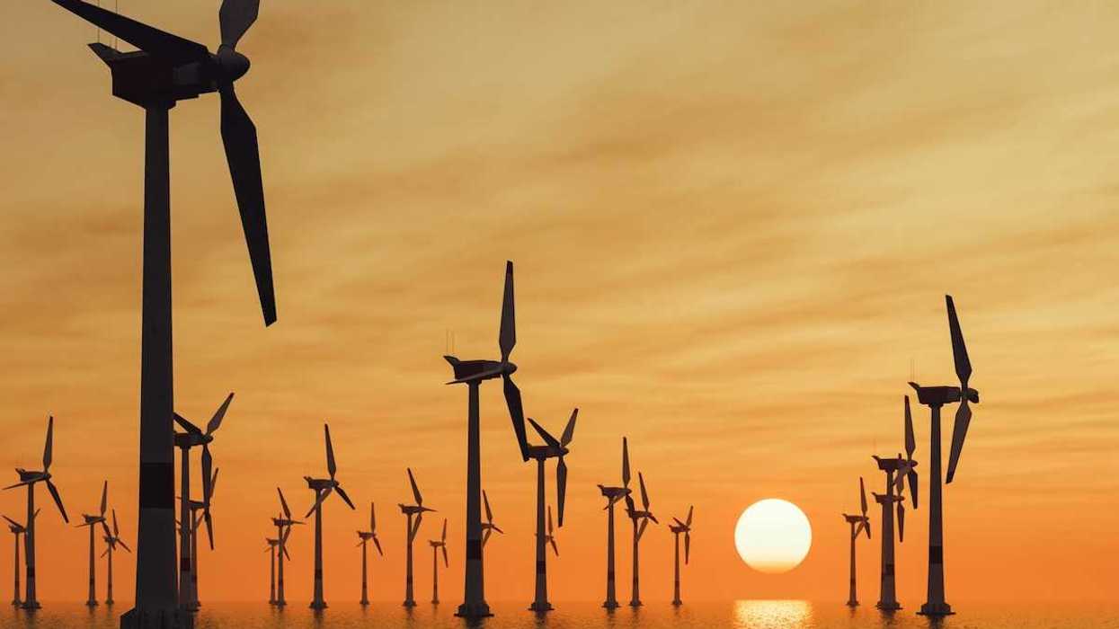 Offshore wind turbines against a setting sun