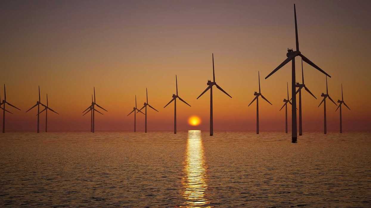 Offshore wind turbines against setting sun