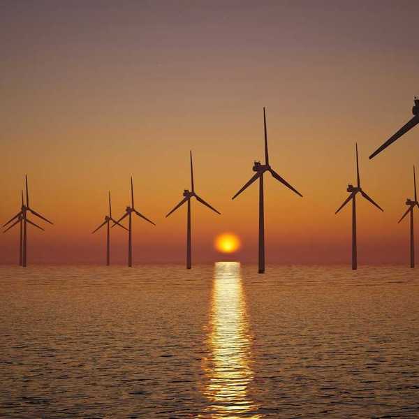 Offshore wind turbines against setting sun