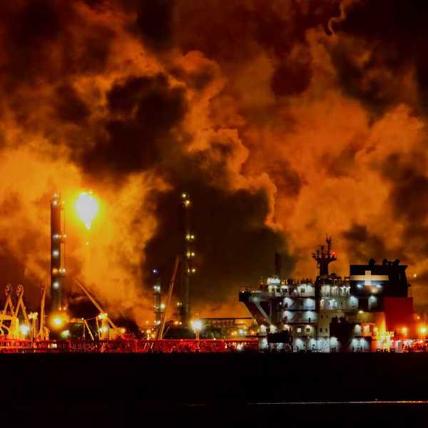 Oil and gas facility flaring excess methane at night