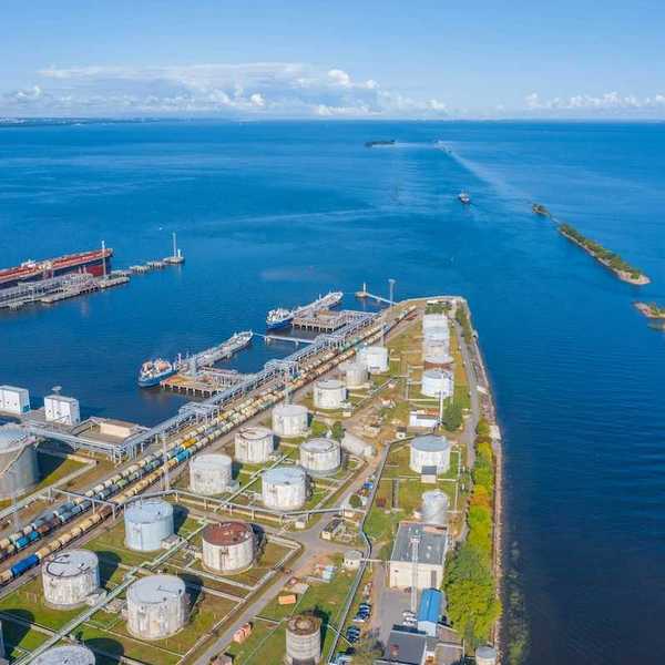 Oil and gas terminal. Storage tanks adjacent to large expansive waterway.