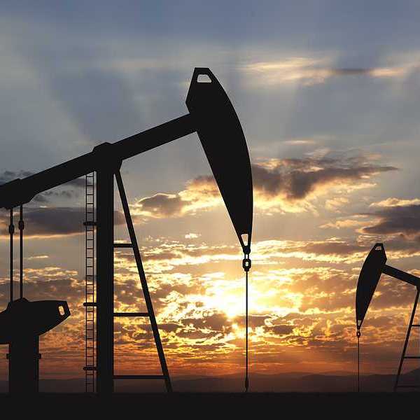 Oil pump oil rig energy industrial machine for petroleum in the sunset background