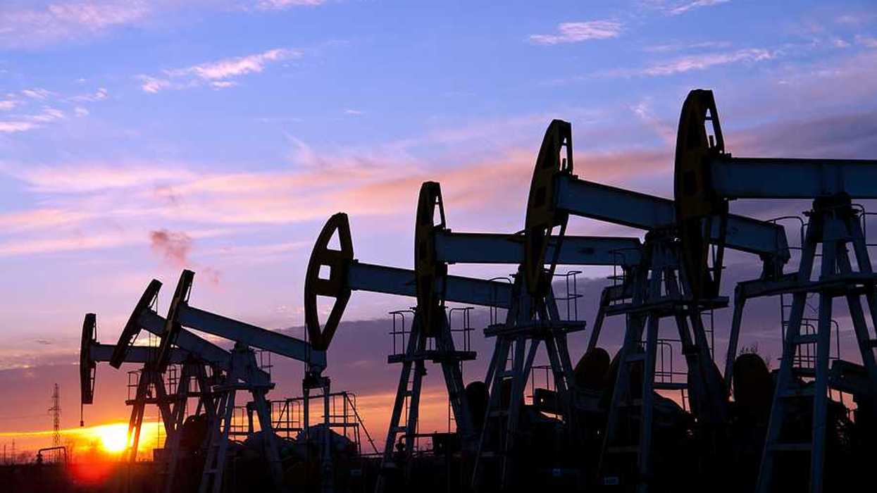 Oil pumps against a sunset sky background