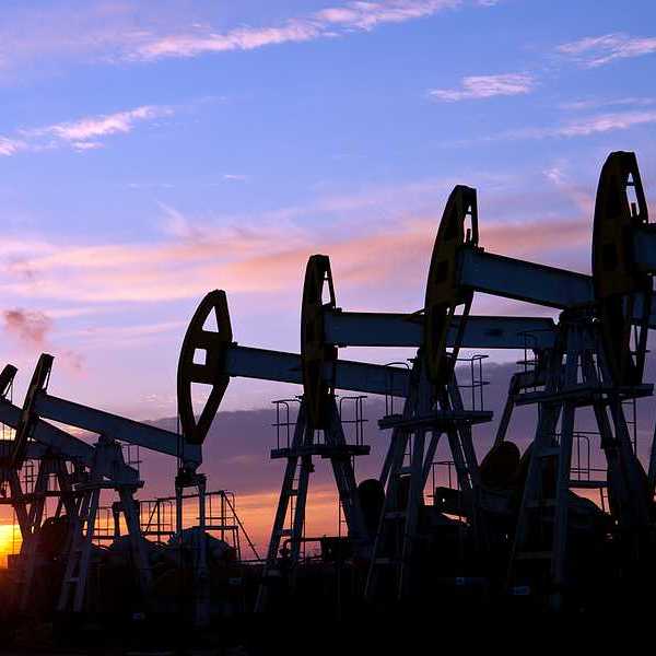 Oil pumps against a sunset sky background