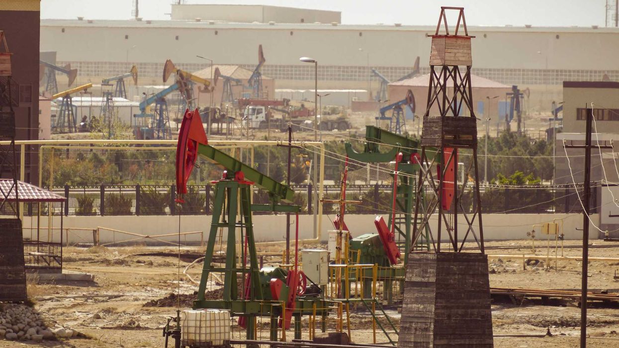 Oil pumps are operating in an industrial landscape.