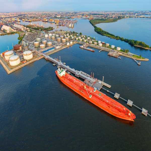Oil tankers at a terminal full of storage tanks