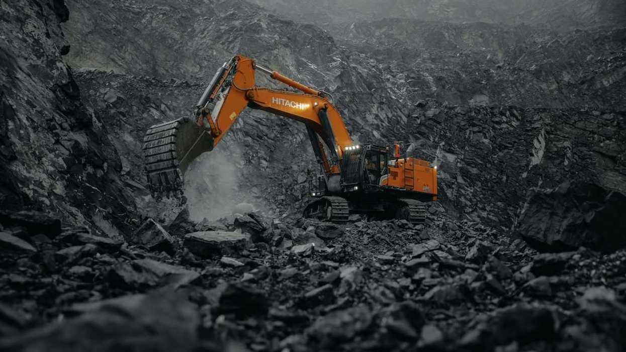 Orange Hitachi excavator working a coal mine.