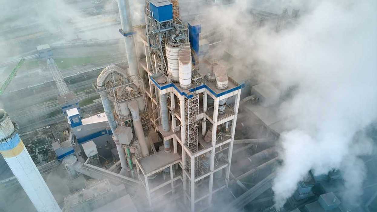 Overhead shot of a cement making facility engulfed in emissions