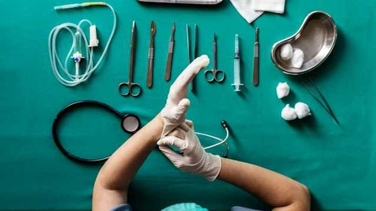 Overhead view of a nurse prepping a surgical tool table