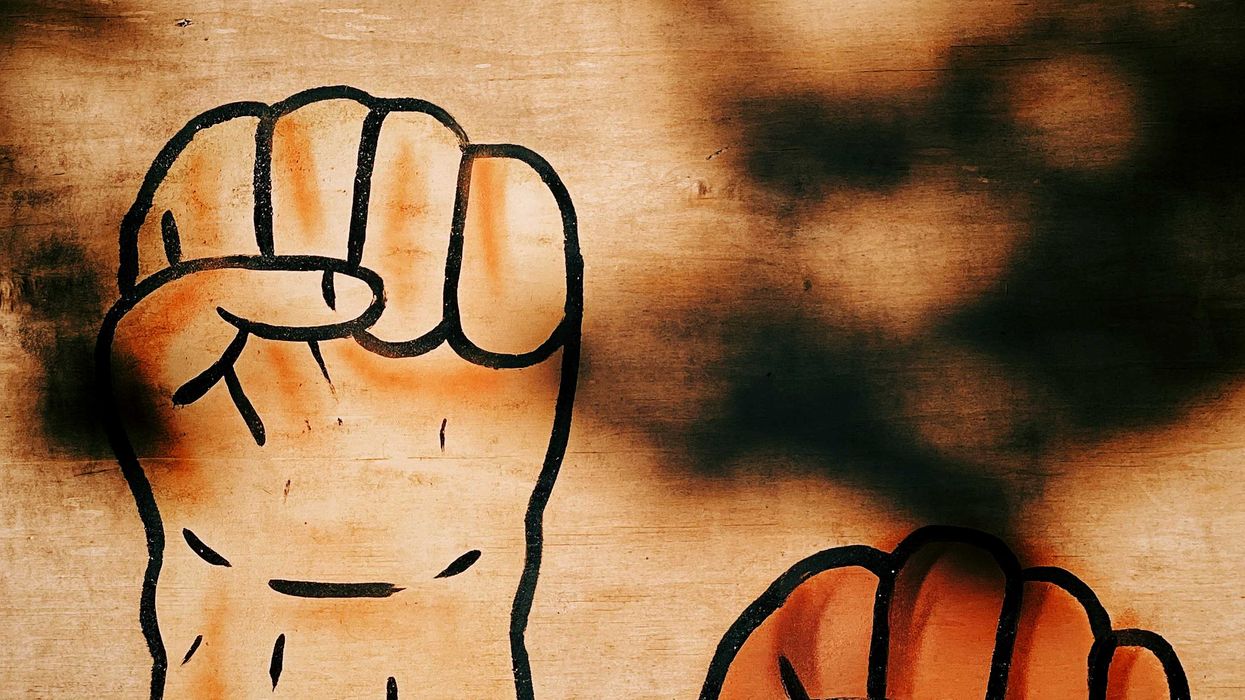 painted image of two fists clenched.